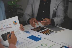 Close up of Business team analyzing income charts and graphs with modern laptop computer. Business analysis and strategy concept. photo