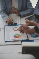 Close up of Business team analyzing income charts and graphs with modern laptop computer. Business analysis and strategy concept. photo