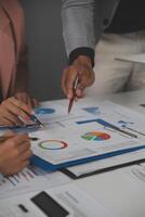 Close up of Business team analyzing income charts and graphs with modern laptop computer. Business analysis and strategy concept. photo