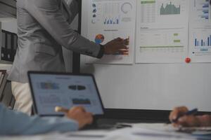 Close up of Business team analyzing income charts and graphs with modern laptop computer. Business analysis and strategy concept. photo