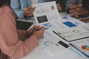 Close up of Business team analyzing income charts and graphs with modern laptop computer. Business analysis and strategy concept. photo