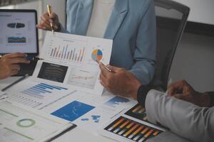 Close up of Business team analyzing income charts and graphs with modern laptop computer. Business analysis and strategy concept. photo