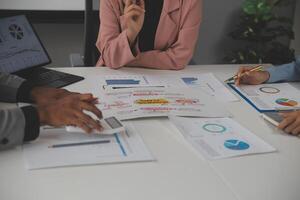 Close up of Business team analyzing income charts and graphs with modern laptop computer. Business analysis and strategy concept. photo