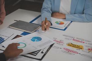 Close up of Business team analyzing income charts and graphs with modern laptop computer. Business analysis and strategy concept. photo