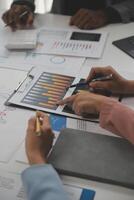 Close up of Business team analyzing income charts and graphs with modern laptop computer. Business analysis and strategy concept. photo