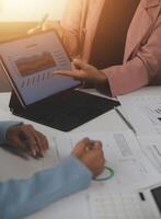 Close up of Business team analyzing income charts and graphs with modern laptop computer. Business analysis and strategy concept. photo