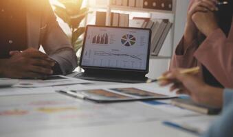 Close up of Business team analyzing income charts and graphs with modern laptop computer. Business analysis and strategy concept. photo