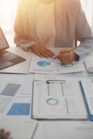 Close up of Business team analyzing income charts and graphs with modern laptop computer. Business analysis and strategy concept. photo