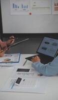 Close up of Business team analyzing income charts and graphs with modern laptop computer. Business analysis and strategy concept. photo