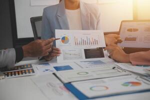 Close up of Business team analyzing income charts and graphs with modern laptop computer. Business analysis and strategy concept. photo