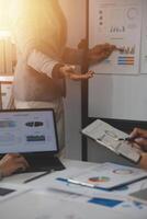 Close up of Business team analyzing income charts and graphs with modern laptop computer. Business analysis and strategy concept. photo