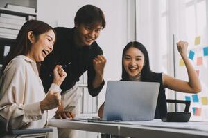 Financial analysts analyze business financial reports on a digital tablet planning investment project during a discussion at a meeting of corporate showing the results of their successful teamwork. photo