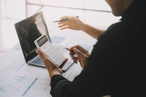 Financial analysts analyze business financial reports on a digital tablet planning investment project during a discussion at a meeting of corporate showing the results of their successful teamwork. photo