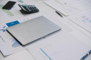 Financial analysts analyze business financial reports on a digital tablet planning investment project during a discussion at a meeting of corporate showing the results of their successful teamwork. photo