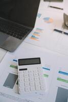 Financial analysts analyze business financial reports on a digital tablet planning investment project during a discussion at a meeting of corporate showing the results of their successful teamwork. photo
