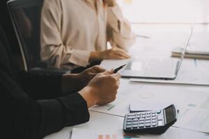 Financial analysts analyze business financial reports on a digital tablet planning investment project during a discussion at a meeting of corporate showing the results of their successful teamwork. photo