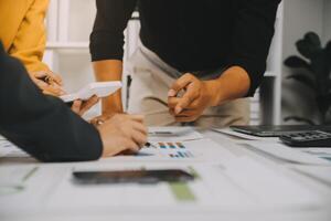 Financial analysts analyze business financial reports on a digital tablet planning investment project during a discussion at a meeting of corporate showing the results of their successful teamwork. photo