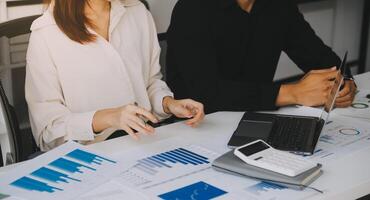 Financial analysts analyze business financial reports on a digital tablet planning investment project during a discussion at a meeting of corporate showing the results of their successful teamwork. photo