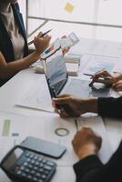 Financial analysts analyze business financial reports on a digital tablet planning investment project during a discussion at a meeting of corporate showing the results of their successful teamwork. photo