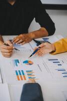 Financial analysts analyze business financial reports on a digital tablet planning investment project during a discussion at a meeting of corporate showing the results of their successful teamwork. photo