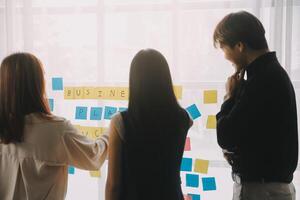 Financial analysts analyze business financial reports on a digital tablet planning investment project during a discussion at a meeting of corporate showing the results of their successful teamwork. photo