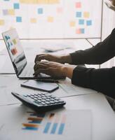 Financial analysts analyze business financial reports on a digital tablet planning investment project during a discussion at a meeting of corporate showing the results of their successful teamwork. photo