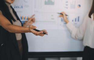 Financial analysts analyze business financial reports on a digital tablet planning investment project during a discussion at a meeting of corporate showing the results of their successful teamwork. photo