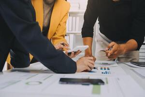 Financial analysts analyze business financial reports on a digital tablet planning investment project during a discussion at a meeting of corporate showing the results of their successful teamwork. photo