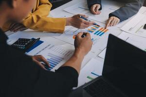 Financial analysts analyze business financial reports on a digital tablet planning investment project during a discussion at a meeting of corporate showing the results of their successful teamwork. photo