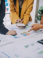 Financial analysts analyze business financial reports on a digital tablet planning investment project during a discussion at a meeting of corporate showing the results of their successful teamwork. photo