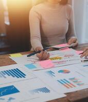 Team of business people working together in the meeting room office, teamwork background charts and graphs banner, double exposure successful teamwork,business planning concept. photo