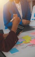 Meeting with business partners to discuss financial advisors to analyze market growth charts in business reports and plan investment strategies. photo