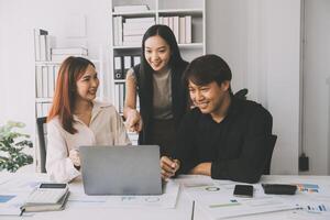 Financial analysts analyze business financial reports on a digital tablet planning investment project during a discussion at a meeting of corporate showing the results of their successful teamwork. photo