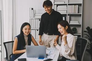 Financial analysts analyze business financial reports on a digital tablet planning investment project during a discussion at a meeting of corporate showing the results of their successful teamwork. photo