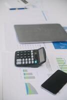Financial analysts analyze business financial reports on a digital tablet planning investment project during a discussion at a meeting of corporate showing the results of their successful teamwork. photo