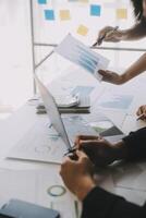 Financial analysts analyze business financial reports on a digital tablet planning investment project during a discussion at a meeting of corporate showing the results of their successful teamwork. photo