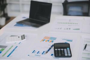 Financial analysts analyze business financial reports on a digital tablet planning investment project during a discussion at a meeting of corporate showing the results of their successful teamwork. photo