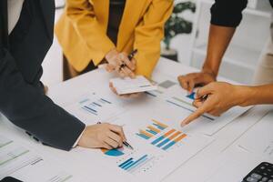 Financial analysts analyze business financial reports on a digital tablet planning investment project during a discussion at a meeting of corporate showing the results of their successful teamwork. photo