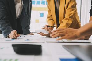 Financial analysts analyze business financial reports on a digital tablet planning investment project during a discussion at a meeting of corporate showing the results of their successful teamwork. photo