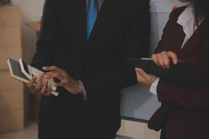 Audit concept,Administrator business man financial inspector and secretary making report calculating balance. Internal Revenue Service checking document. photo