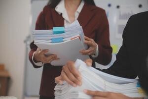 Audit concept,Administrator business man financial inspector and secretary making report calculating balance. Internal Revenue Service checking document. photo