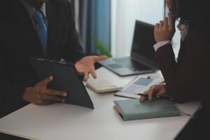 Audit concept,Administrator business man financial inspector and secretary making report calculating balance. Internal Revenue Service checking document. photo