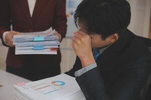 Audit concept,Administrator business man financial inspector and secretary making report calculating balance. Internal Revenue Service checking document. photo
