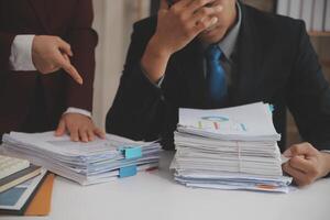 Audit concept,Administrator business man financial inspector and secretary making report calculating balance. Internal Revenue Service checking document. photo