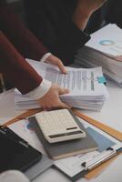 Audit concept,Administrator business man financial inspector and secretary making report calculating balance. Internal Revenue Service checking document. photo