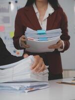 Audit concept,Administrator business man financial inspector and secretary making report calculating balance. Internal Revenue Service checking document. photo