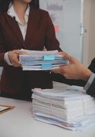 Audit concept,Administrator business man financial inspector and secretary making report calculating balance. Internal Revenue Service checking document. photo