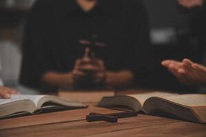 Christian group are praying to god with the bible and sharing the gospel. Concept of faith for god. photo