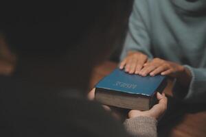Christian group are praying to god with the bible and sharing the gospel. Concept of faith for god. photo