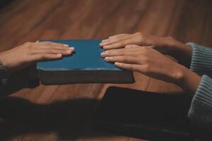 Christian group are praying to god with the bible and sharing the gospel. Concept of faith for god. photo